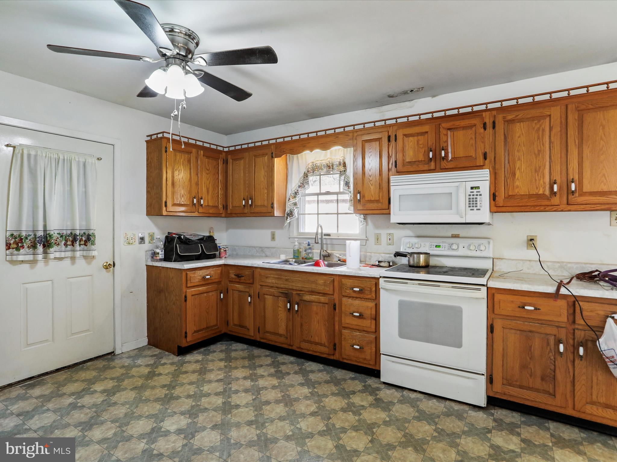 12440 Indian Springs Road Clear Spring, MD 21722 - Photo 15 of 35 a kitchen with stainless steel appliances granite countertop a stove cabinets and window