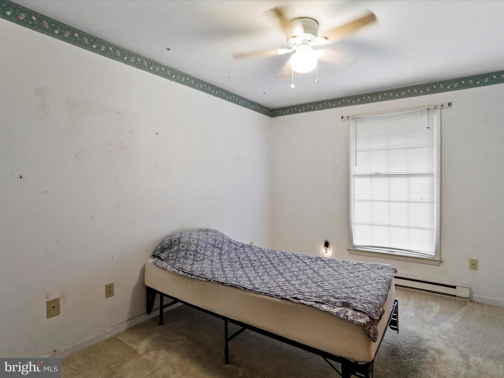 12440 Indian Springs Road Clear Spring, MD 21722 - Photo 30 of 35 a bedroom with a bed and a chandelier fan