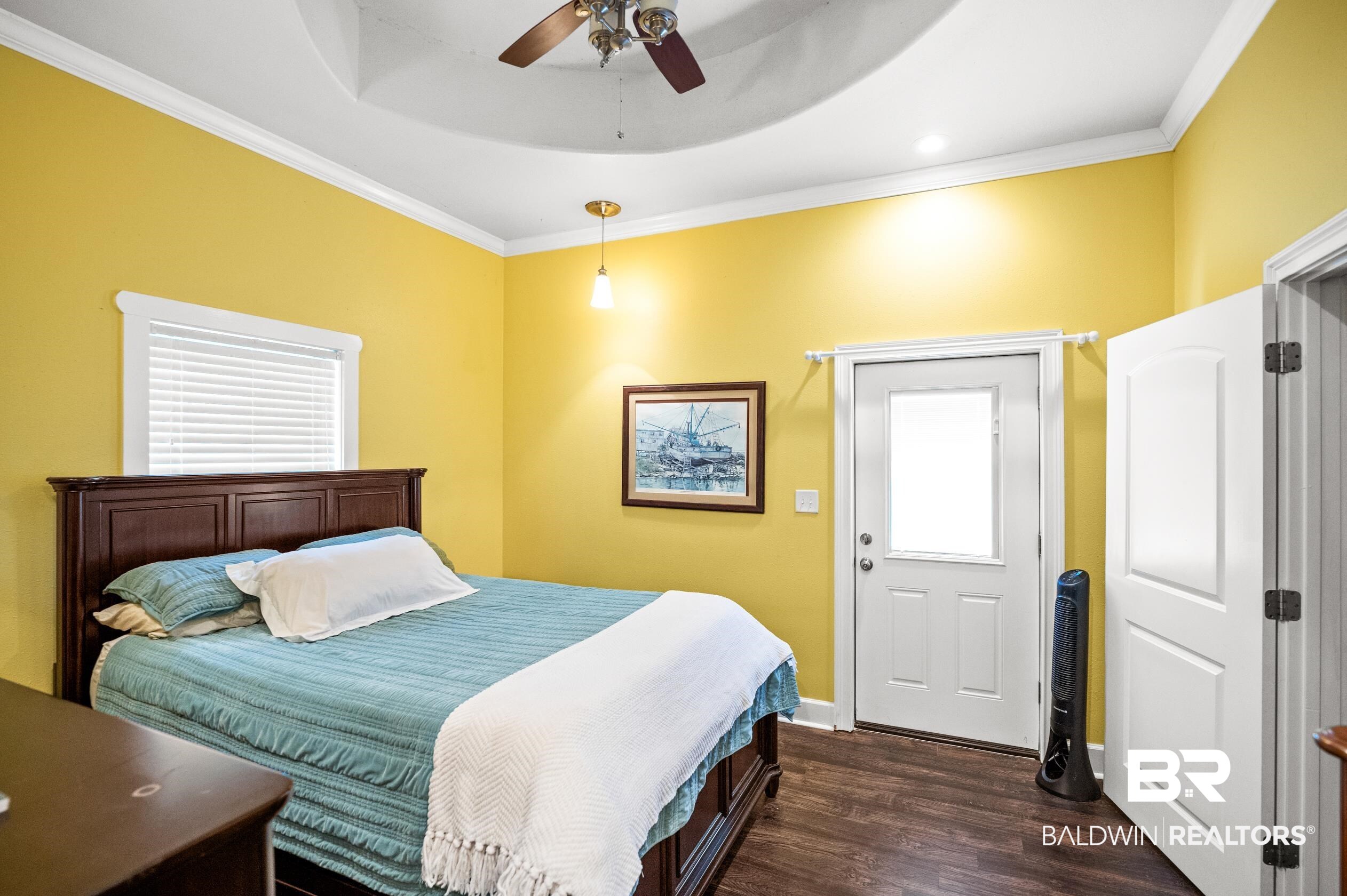13358 County Road 91 Elberta, AL 36530 - Photo 24 of 47 Bedroom featuring ceiling fan, ornamental molding, dark hardwood / wood-style floors, and a raised ceiling