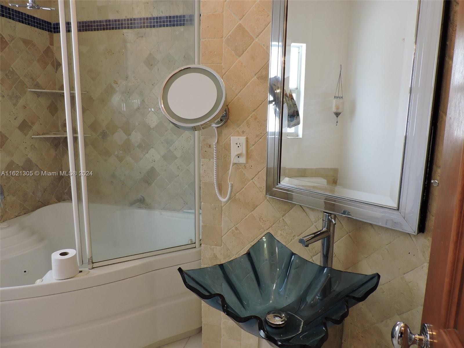 1630 Tyler Street Hollywood, FL 33020 - Photo 11 of 26 a bathroom with a sink mirror vanity and toilet