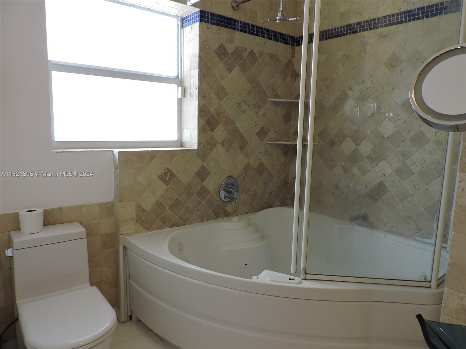 1630 Tyler Street Hollywood, FL 33020 - Photo 16 of 26 a white bath tub sitting next to a toilet