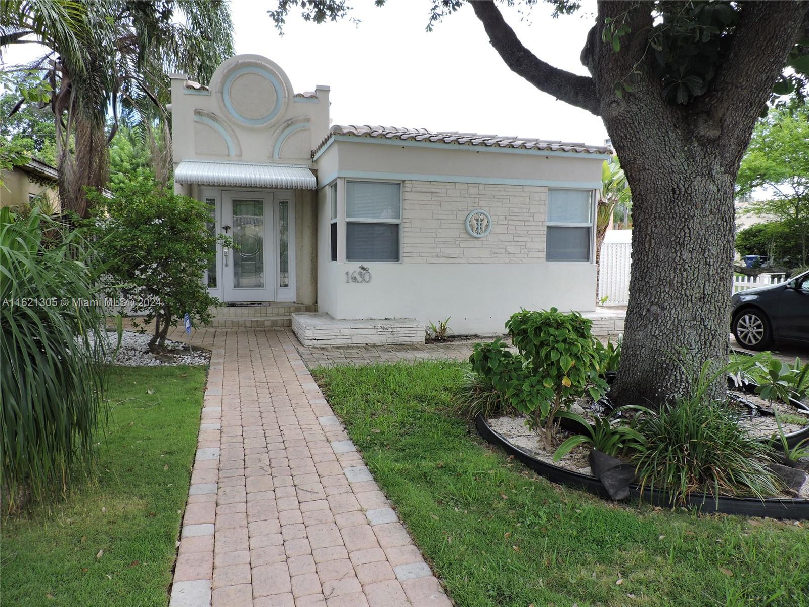 1630 Tyler Street Hollywood, FL 33020 - Photo 2 of 26 a front view of a house with garden