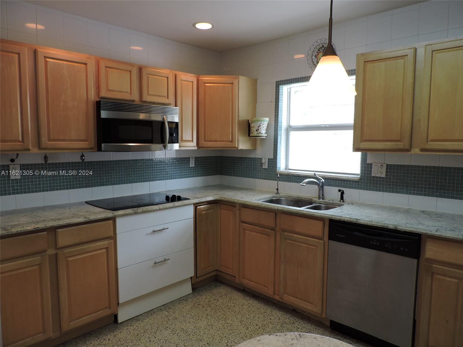 1630 Tyler Street Hollywood, FL 33020 - Photo 7 of 26 a kitchen with sink cabinets and window