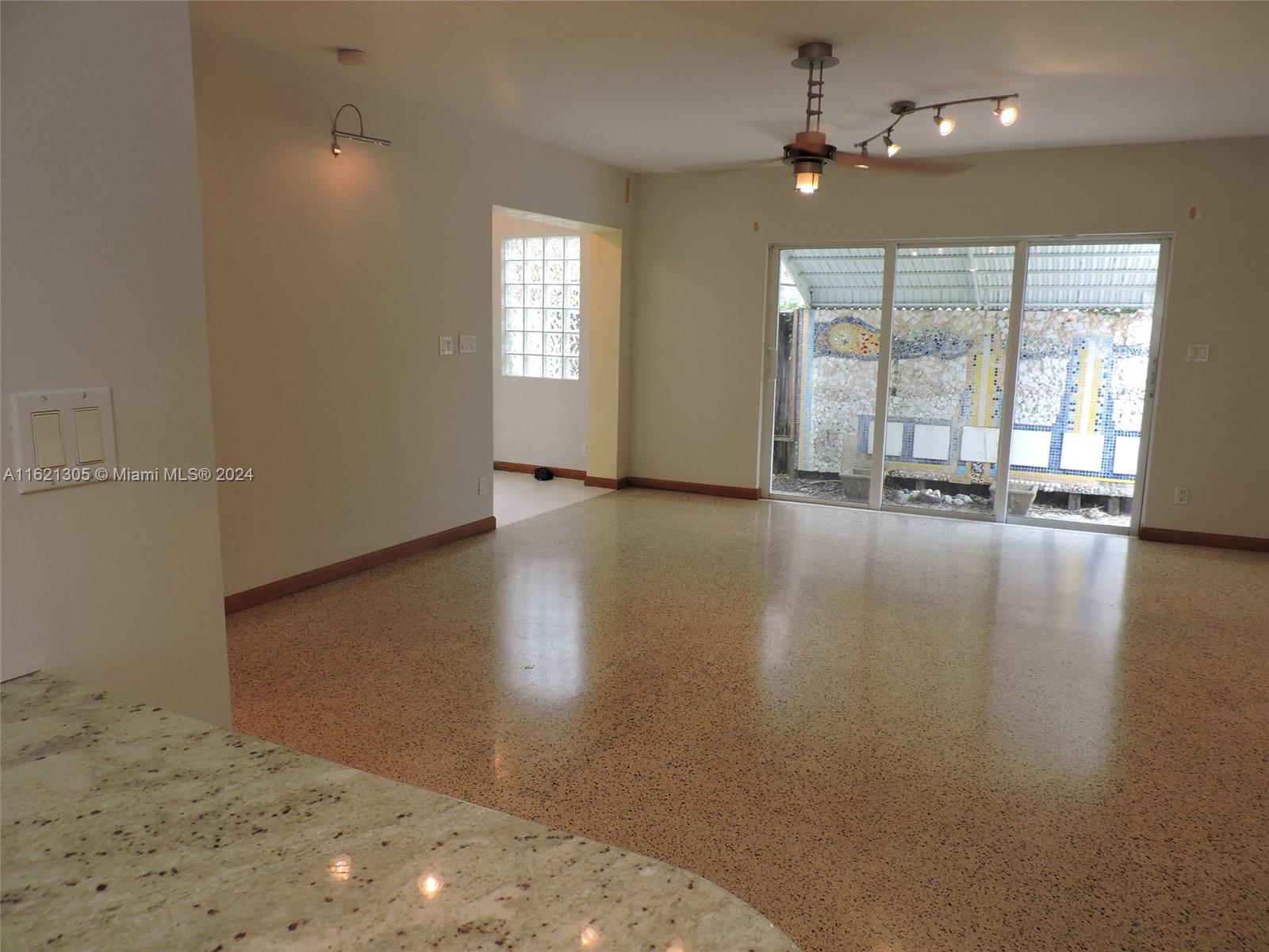 1630 Tyler Street Hollywood, FL 33020 - Photo 10 of 26 an empty room with wooden floor and windows