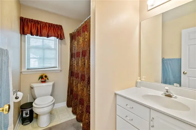 a bathroom with a toilet a sink and a mirror