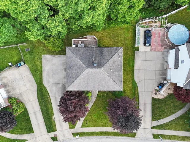 an aerial view of a house with garden space and street view