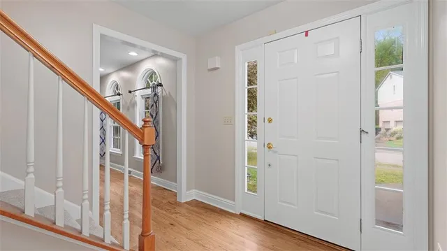 a view of a hallway with wooden floor and entryway