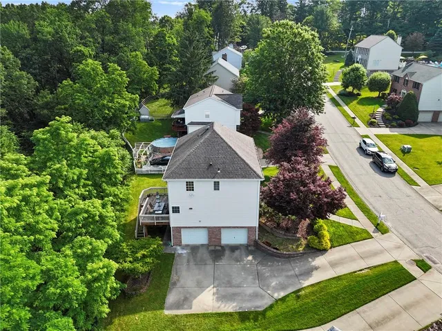 an aerial view of a house with a yard and garden