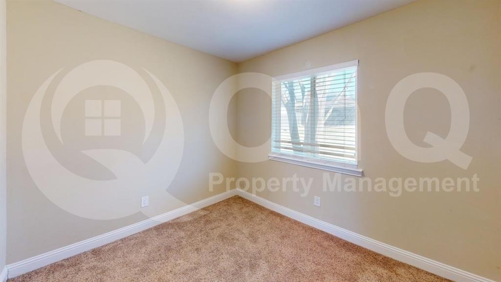 3005 Meandering Way Bedford, TX 76021 - Photo 15 of 24 Neutral-toned walls complement the textured brown carpeting