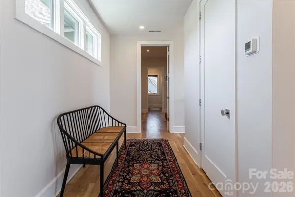 a view of hallway with wooden floor