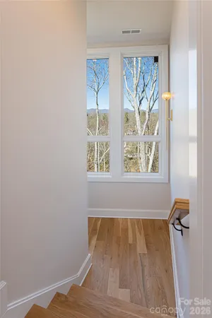 a view of a room with window and a wooden floor