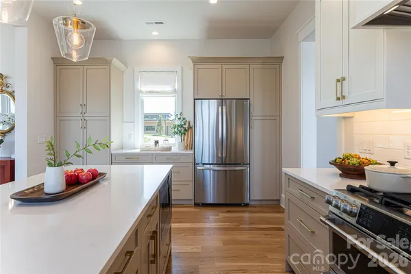a kitchen with granite countertop a stove and a refrigerator