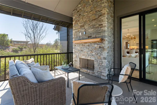 a balcony with furniture and a fireplace