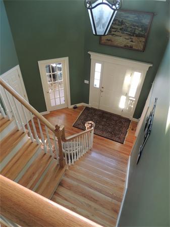 169 Manchaug Road Sutton, MA 01590 - Photo 11 of 30 a view of a livingroom with wooden floor and stairs