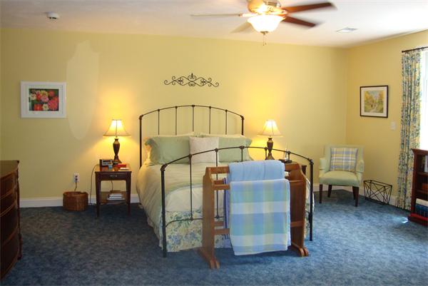 169 Manchaug Road Sutton, MA 01590 - Photo 12 of 30 a bedroom with a bed and a chandelier
