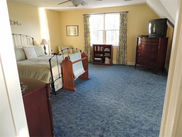 169 Manchaug Road Sutton, MA 01590 - Photo 13 of 30 a bed room with a bed and a tv