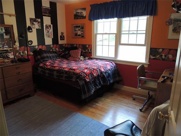 169 Manchaug Road Sutton, MA 01590 - Photo 17 of 30 a bed sitting in a bedroom next to a window