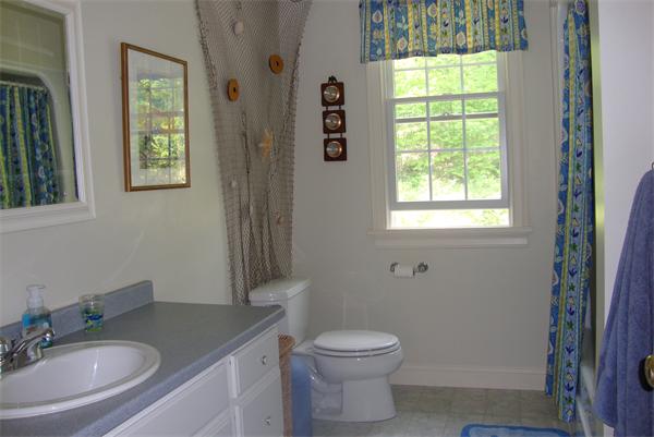 169 Manchaug Road Sutton, MA 01590 - Photo 18 of 30 a bathroom with a granite countertop toilet a sink a mirror and a window