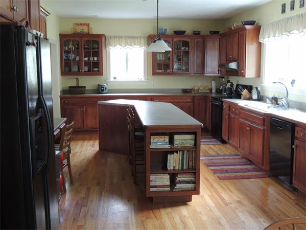 169 Manchaug Road Sutton, MA 01590 - Photo 3 of 30 a kitchen with kitchen island granite countertop a refrigerator stove and sink