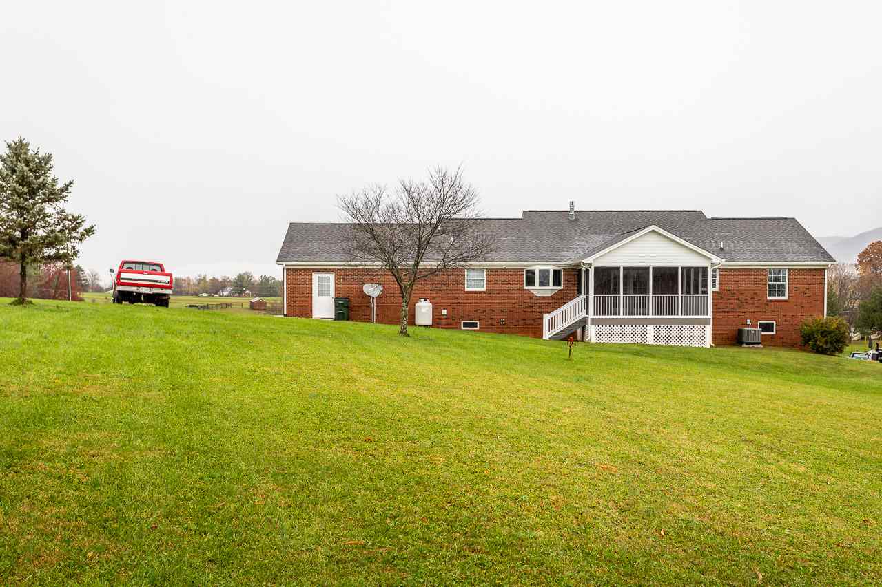 38 Spottswood Road Raphine, VA 24472 - Photo 33 of 40 a front view of a house with a garden and deck