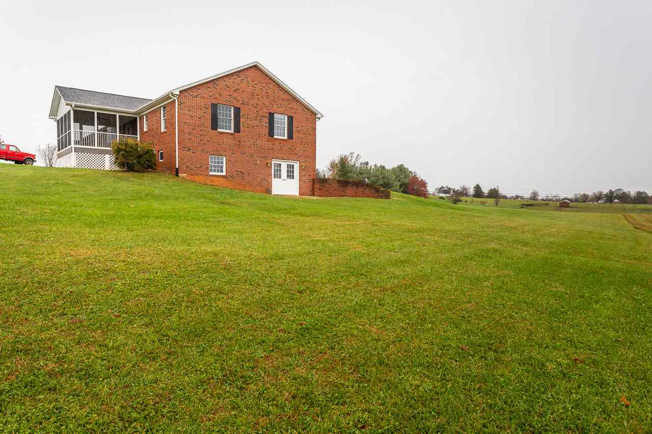 38 Spottswood Road Raphine, VA 24472 - Photo 36 of 40 a house that is sitting in the grass with large trees
