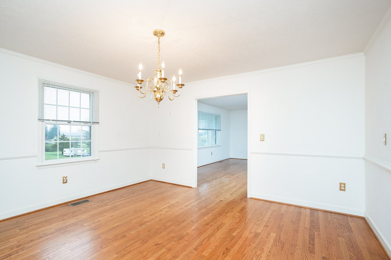 38 Spottswood Road Raphine, VA 24472 - Photo 6 of 40 an empty room with wooden floor chandelier and windows