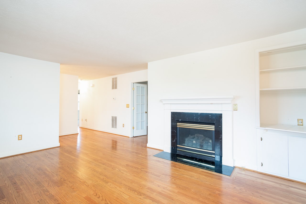 38 Spottswood Road Raphine, VA 24472 - Photo 7 of 40 a view of an empty room with wooden floor fireplace and a window
