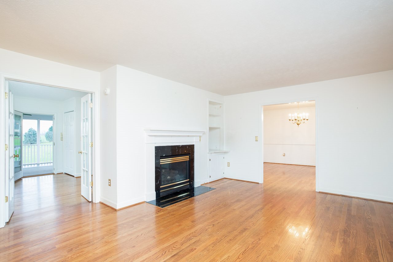38 Spottswood Road Raphine, VA 24472 - Photo 10 of 40 an empty room with wooden floor and fireplace