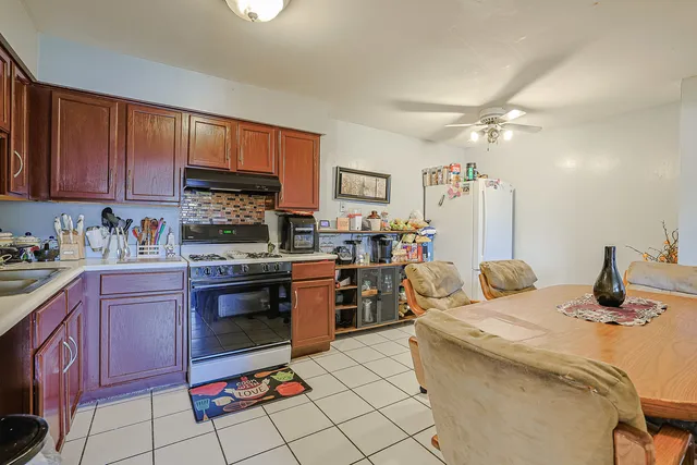 a kitchen with stainless steel appliances granite countertop a sink stove and cabinets