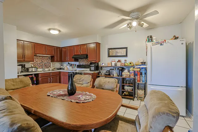 a dining table with chairs and kitchen view