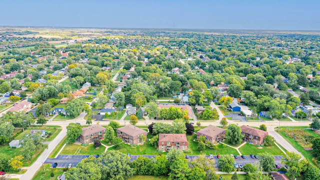 an aerial view of residential houses with outdoor space and swimming pool