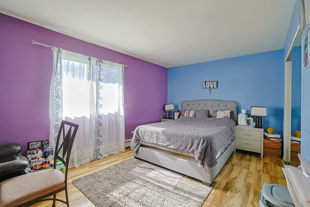 a bedroom with a bed a table and chair