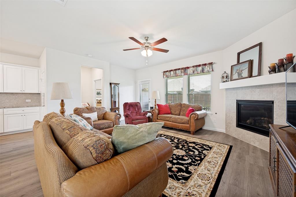 413 Wiggins Way Van Alstyne, TX 75495 - Photo 13 of 25 Expansive living area featuring wood-finish flooring and a ceiling fan