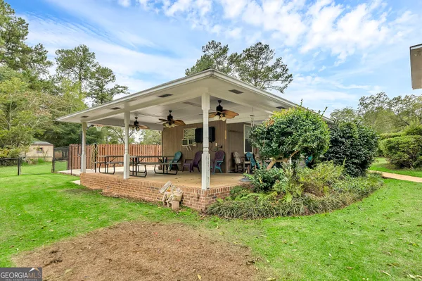 an aerial view of a house with outdoor space pool seating area and yard
