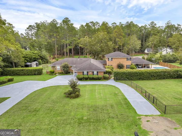 an aerial view of a house with yard swimming pool and outdoor seating