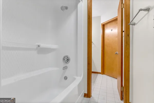 a bedroom with a bed and a ceiling fan