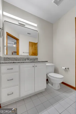 a white toilet sitting next to a shower
