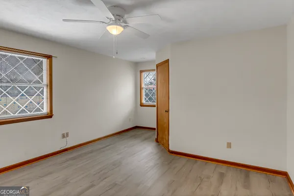 wooden floor in an empty room with a window