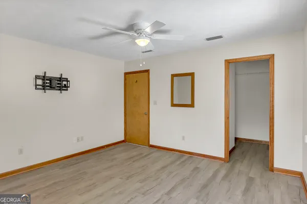 a kitchen with stainless steel appliances granite countertop a refrigerator a stove a sink dishwasher and wooden cabinets with wooden floor