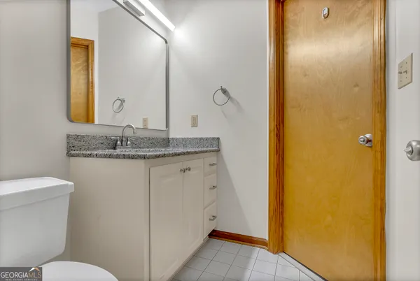 a kitchen with stainless steel appliances granite countertop a refrigerator a sink dishwasher a stove and a wooden cabinets