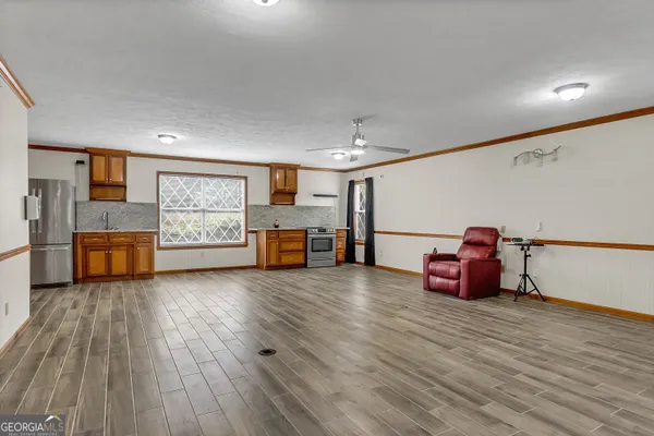 a kitchen with stainless steel appliances granite countertop a refrigerator and a stove