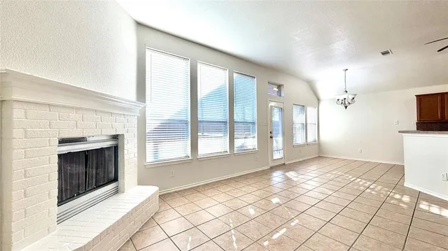 a view of a livingroom with a fireplace and window