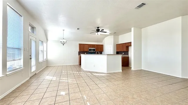 a view of a kitchen with wooden floor and a kitchen