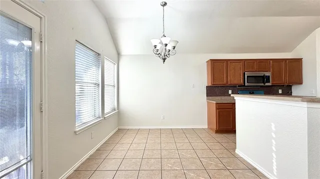 a view of a kitchen with a sink dishwasher and a refrigerator