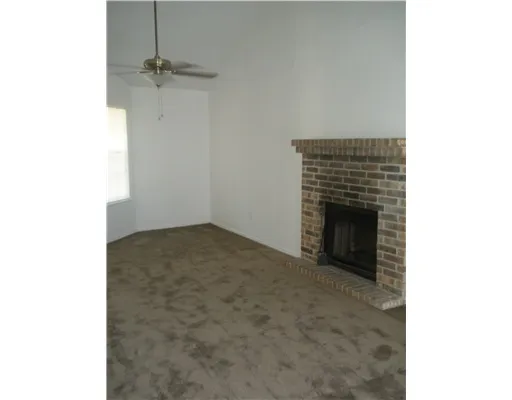 a view of empty room with a fireplace