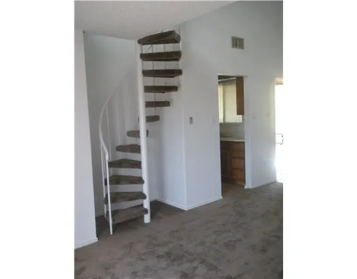 a view of a bedroom with stairs and closet