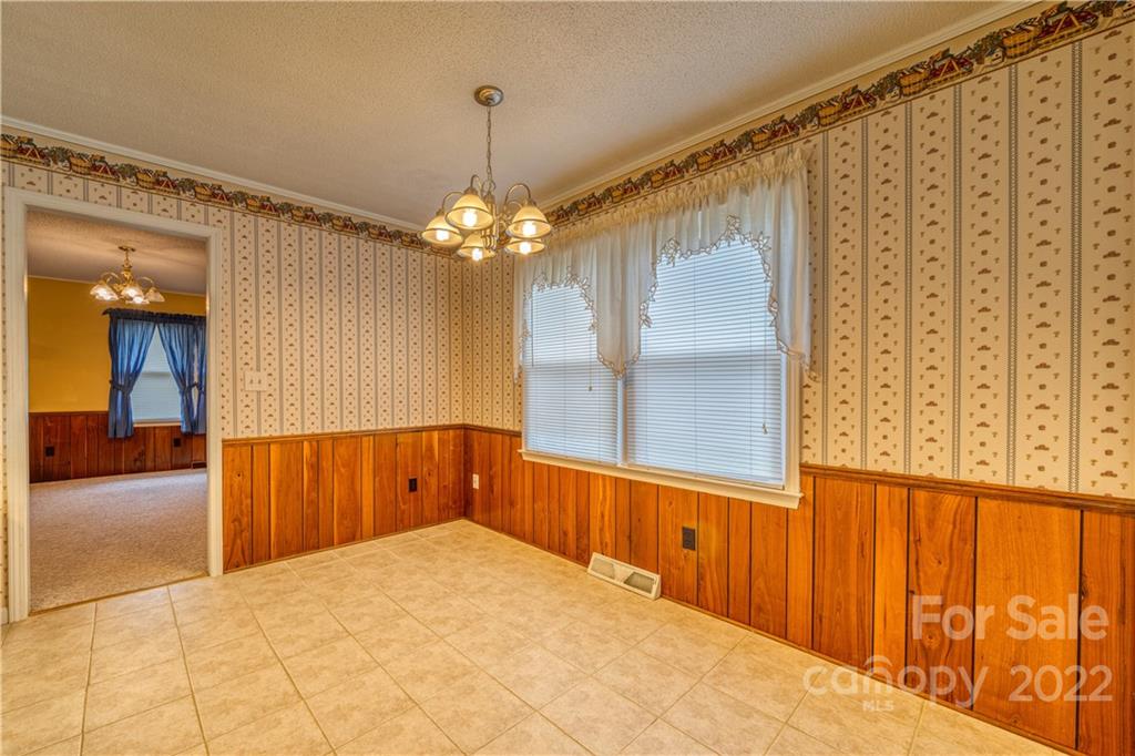 740 Rainey Road Salisbury, NC 28146 - Photo 13 of 32 a view of a hallway with wooden floor and chandelier
