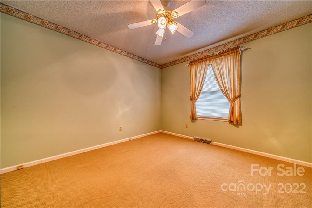740 Rainey Road Salisbury, NC 28146 - Photo 27 of 32 an empty room with a window and a ceiling fan