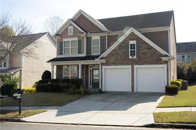 a front view of a house with a yard