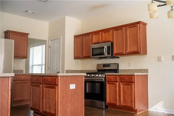 a stove top oven sitting inside of a kitchen